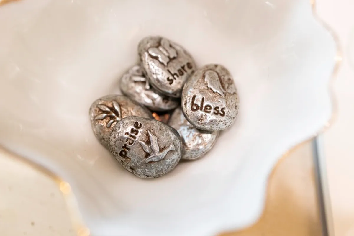 Inspirational stones engraved with praise, bless, and share